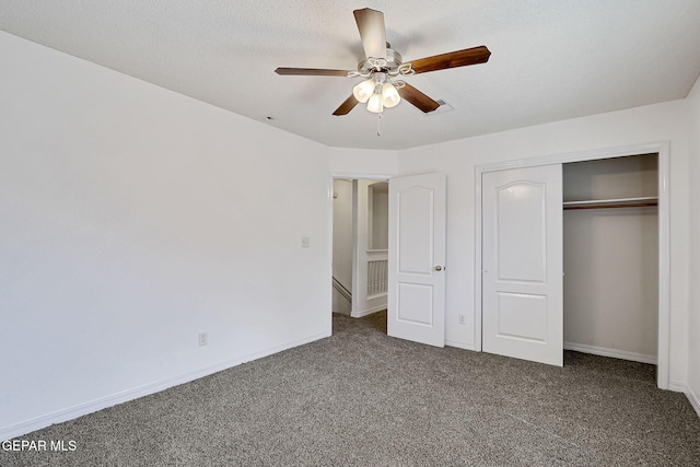 unfurnished bedroom featuring a closet, baseboards, carpet, and a textured ceiling