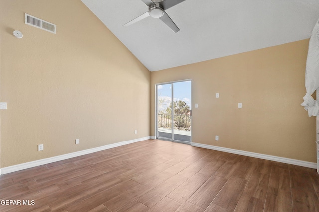 empty room featuring wood finished floors, baseboards, visible vents, high vaulted ceiling, and ceiling fan