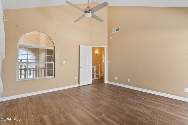 unfurnished room featuring ceiling fan, visible vents, baseboards, and wood finished floors