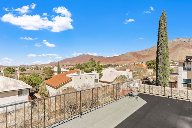 view of patio featuring a mountain view, a residential view, and a balcony