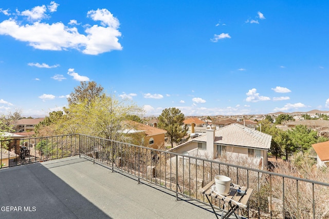 view of patio with a residential view and a balcony