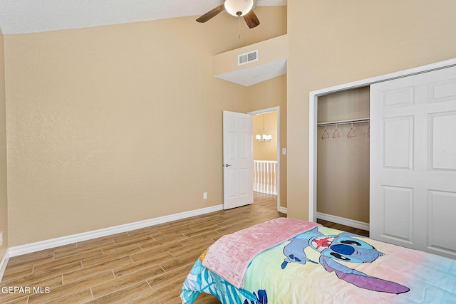 bedroom with baseboards, visible vents, a closet, and light wood-type flooring