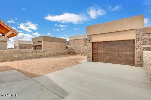 exterior space with concrete driveway and a garage