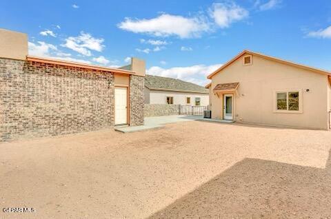 rear view of property with stucco siding