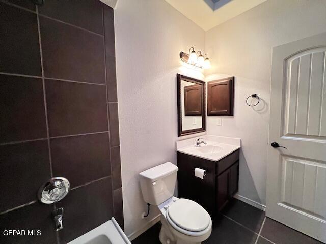 full bath with vanity, baseboards, tile patterned flooring, bathtub / shower combination, and toilet