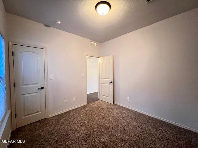 unfurnished bedroom featuring baseboards and carpet floors