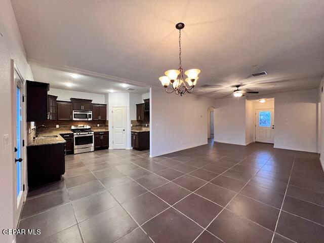 kitchen featuring visible vents, a sink, appliances with stainless steel finishes, ceiling fan with notable chandelier, and open floor plan