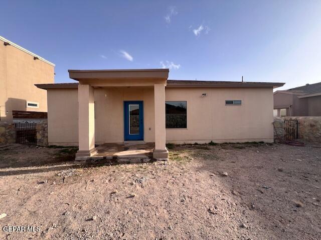 back of house featuring a patio area, fence, and stucco siding