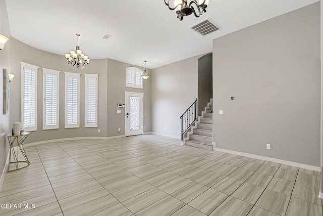 entryway featuring a chandelier, visible vents, stairs, and baseboards