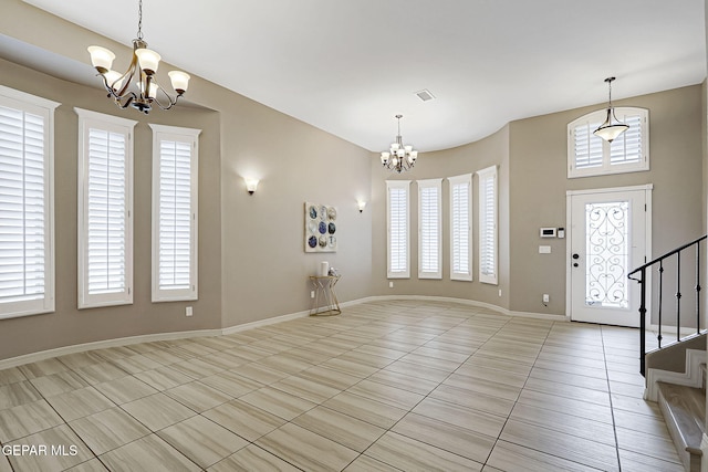 foyer featuring visible vents, baseboards, stairway, light tile patterned floors, and a notable chandelier