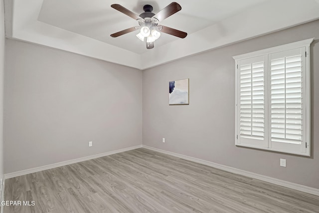 unfurnished room with baseboards, ceiling fan, and wood finished floors