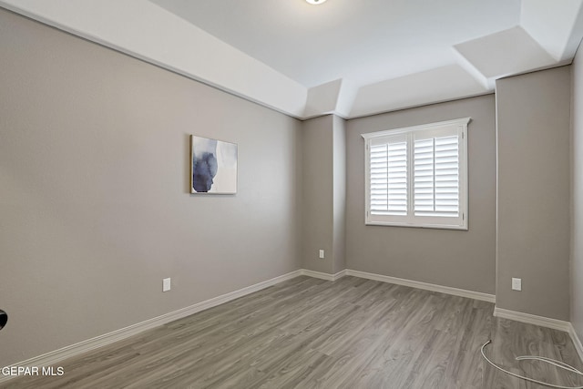 empty room with wood finished floors and baseboards