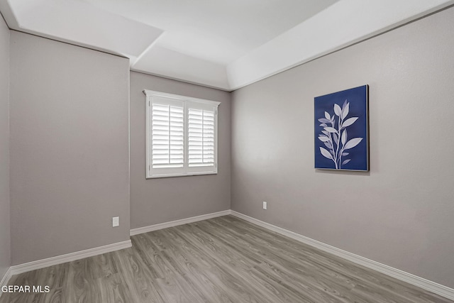 empty room featuring baseboards and wood finished floors