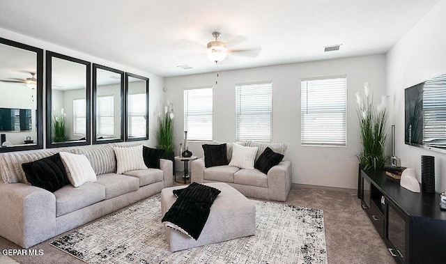 living area with visible vents, ceiling fan, and carpet floors
