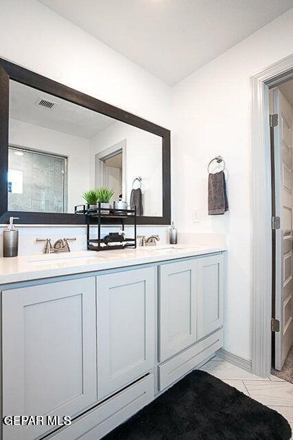 full bath featuring a sink and double vanity