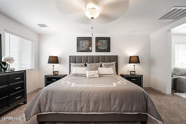 bedroom with visible vents, baseboards, carpet, and ceiling fan