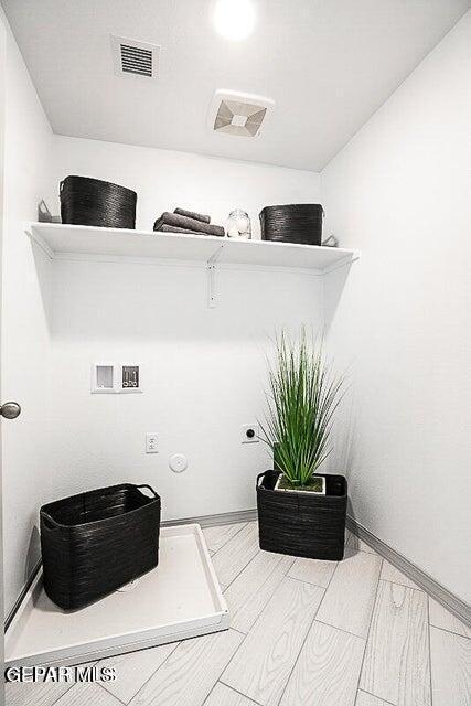 laundry room featuring visible vents, hookup for an electric dryer, baseboards, and washer hookup