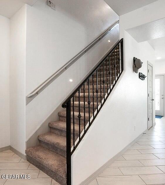 staircase featuring wood finished floors