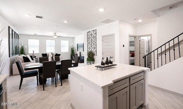kitchen featuring light wood-type flooring, visible vents, and gray cabinets