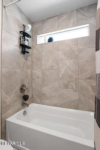 full bathroom featuring shower / bathtub combination with curtain