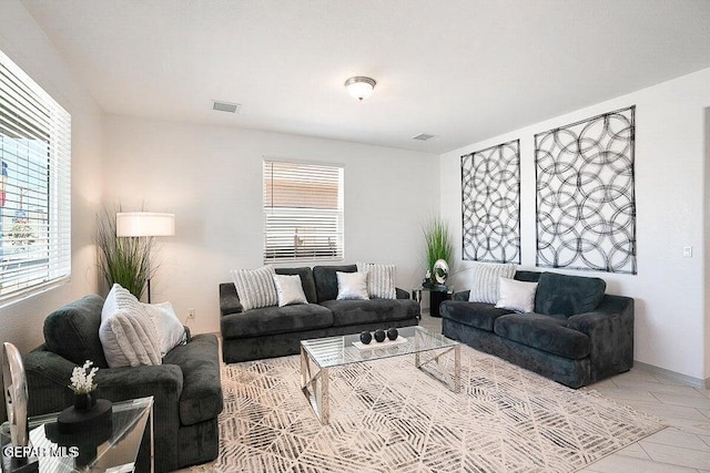 living area with visible vents and a healthy amount of sunlight