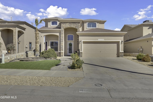 view of front facade featuring stone siding, stucco siding, concrete driveway, and a garage