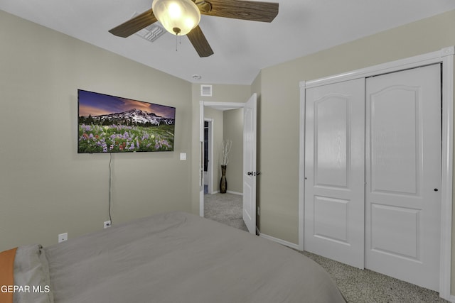 bedroom featuring carpet, baseboards, visible vents, ceiling fan, and a closet