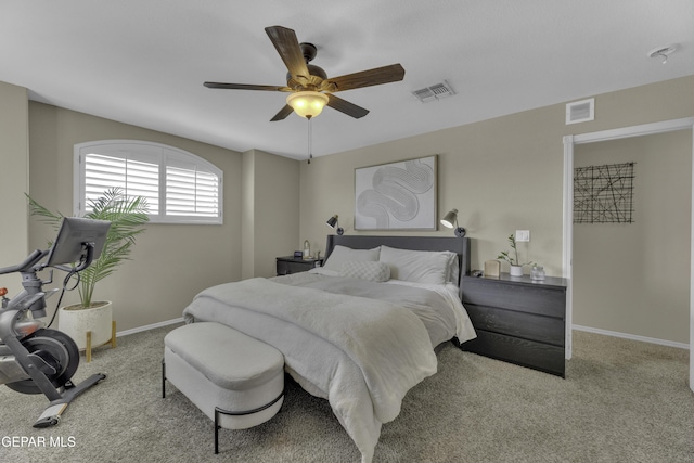 carpeted bedroom featuring visible vents, baseboards, and a ceiling fan