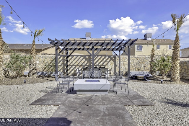 view of patio / terrace featuring fence, a pergola, and an outdoor fire pit