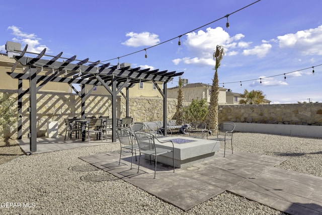 view of patio / terrace featuring fence, a pergola, and an outdoor fire pit