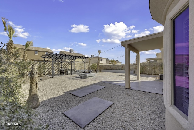 view of yard featuring a patio area, a pergola, and a fenced backyard