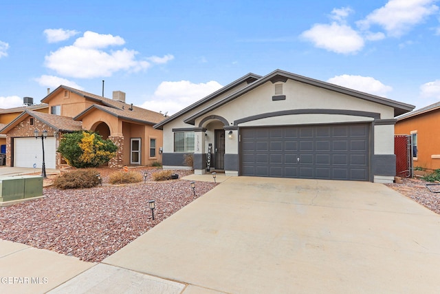 single story home with stucco siding, concrete driveway, and a garage