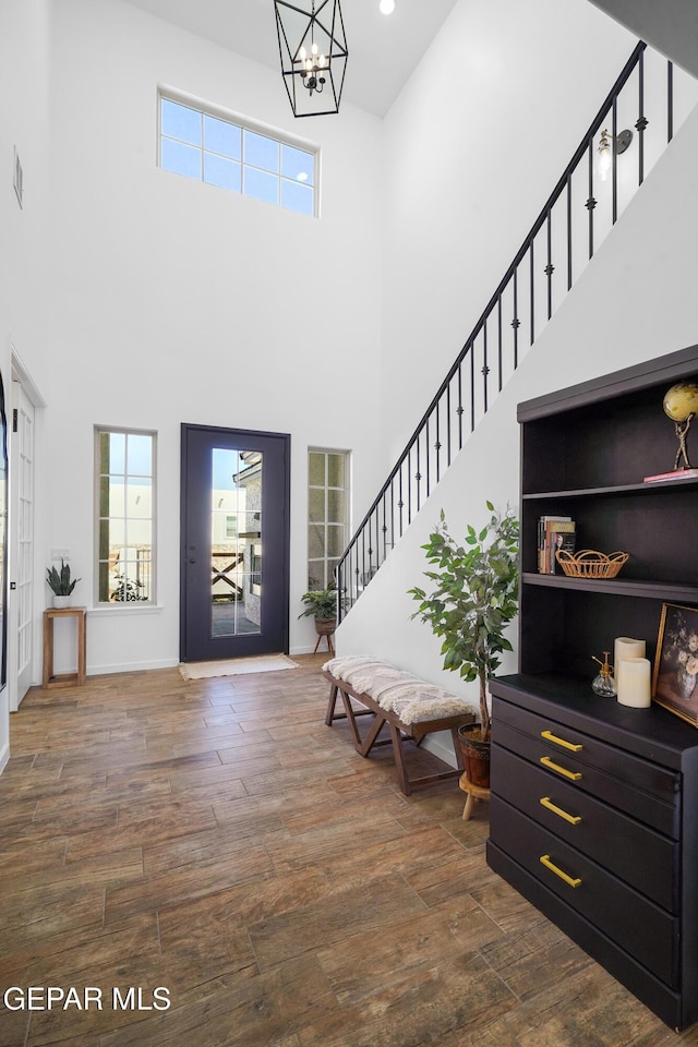 7402 Wooden Nickel Dr, El Paso, TX 79911 - entryway featuring dark wood-style flooring, a chandelier, stairway, and a healthy amount of sunlight