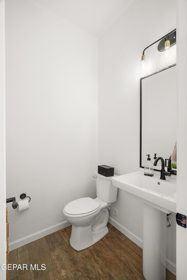 7402 Wooden Nickel Dr, El Paso, TX 79911 - half bath featuring baseboards, wood finished floors, and toilet