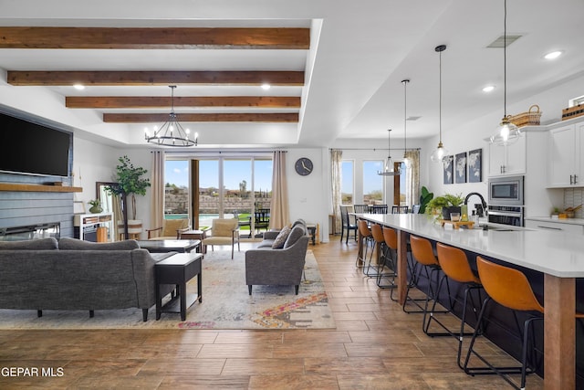 7402 Wooden Nickel Dr, El Paso, TX 79911 - living area with visible vents, beam ceiling, recessed lighting, and an inviting chandelier