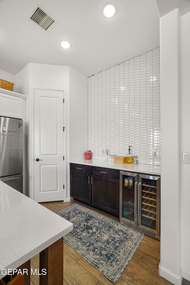 7402 Wooden Nickel Dr, El Paso, TX 79911 - bar featuring a dry bar, beverage cooler, freestanding refrigerator, visible vents, and wood finished floors