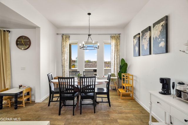 7402 Wooden Nickel Dr, El Paso, TX 79911 - dining space featuring baseboards, wood finished floors, and an inviting chandelier