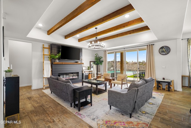7402 Wooden Nickel Dr, El Paso, TX 79911 - living room featuring a large fireplace, baseboards, wood finished floors, beam ceiling, and an inviting chandelier