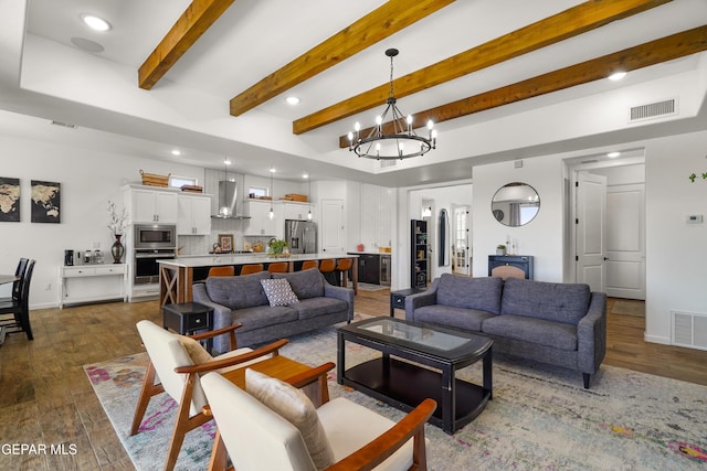 7402 Wooden Nickel Dr, El Paso, TX 79911 - living area featuring visible vents, a notable chandelier, and wood finished floors