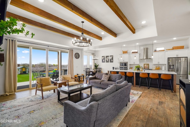 7402 Wooden Nickel Dr, El Paso, TX 79911 - living area with light wood-style flooring, an inviting chandelier, recessed lighting, and beamed ceiling