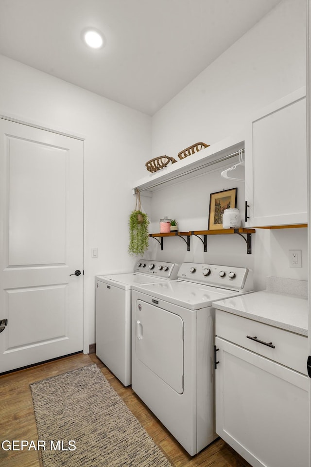 7402 Wooden Nickel Dr, El Paso, TX 79911 - washroom with washer and clothes dryer, cabinet space, and wood finished floors