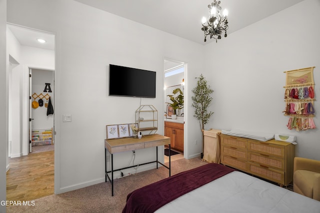 7402 Wooden Nickel Dr, El Paso, TX 79911 - bedroom with light colored carpet, a notable chandelier, baseboards, and ensuite bath