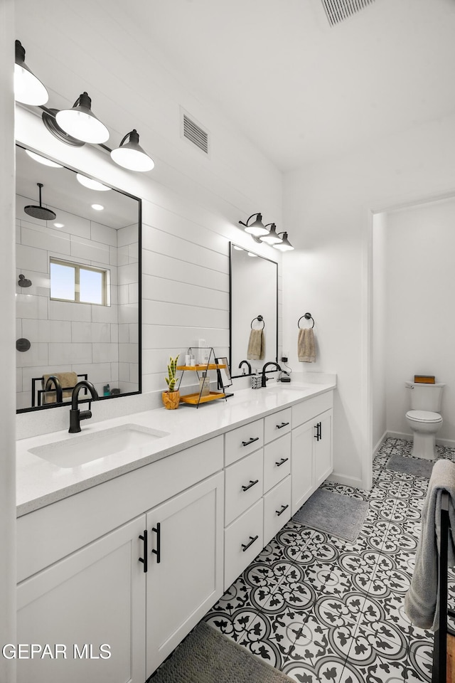 7402 Wooden Nickel Dr, El Paso, TX 79911 - bathroom featuring toilet, tile patterned floors, a sink, visible vents, and double vanity