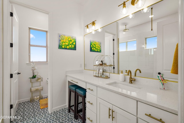 7402 Wooden Nickel Dr, El Paso, TX 79911 - bathroom featuring baseboards, tiled shower, and vanity