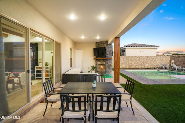 7402 Wooden Nickel Dr, El Paso, TX 79911 - view of patio / terrace featuring an outdoor stone fireplace, a fenced in pool, outdoor dining space, and fence