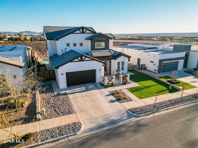 7402 Wooden Nickel Dr, El Paso, TX 79911 - modern farmhouse featuring a standing seam roof, driveway, stucco siding, and fence