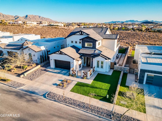 7402 Wooden Nickel Dr, El Paso, TX 79911 - view of front of property featuring concrete driveway, stucco siding, fence, an attached garage, and a mountain view