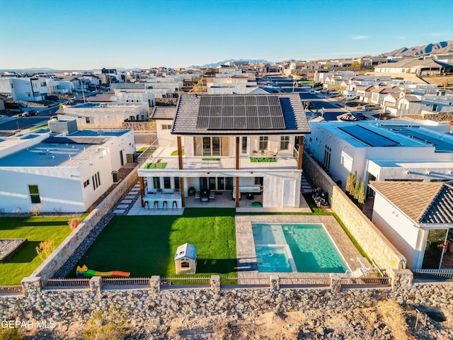 7402 Wooden Nickel Dr, El Paso, TX 79911 - rear view of house with a patio, a fenced backyard, solar panels, a residential view, and a yard