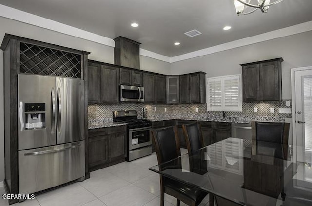 kitchen featuring light tile patterned floors, visible vents, backsplash, and appliances with stainless steel finishes