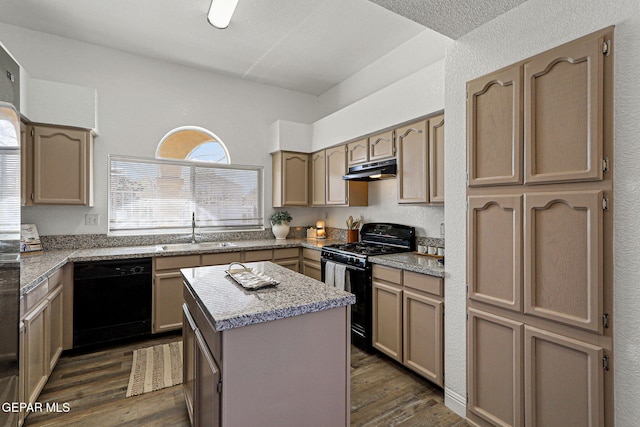 kitchen with dark wood-type flooring, black appliances, a sink, under cabinet range hood, and a center island